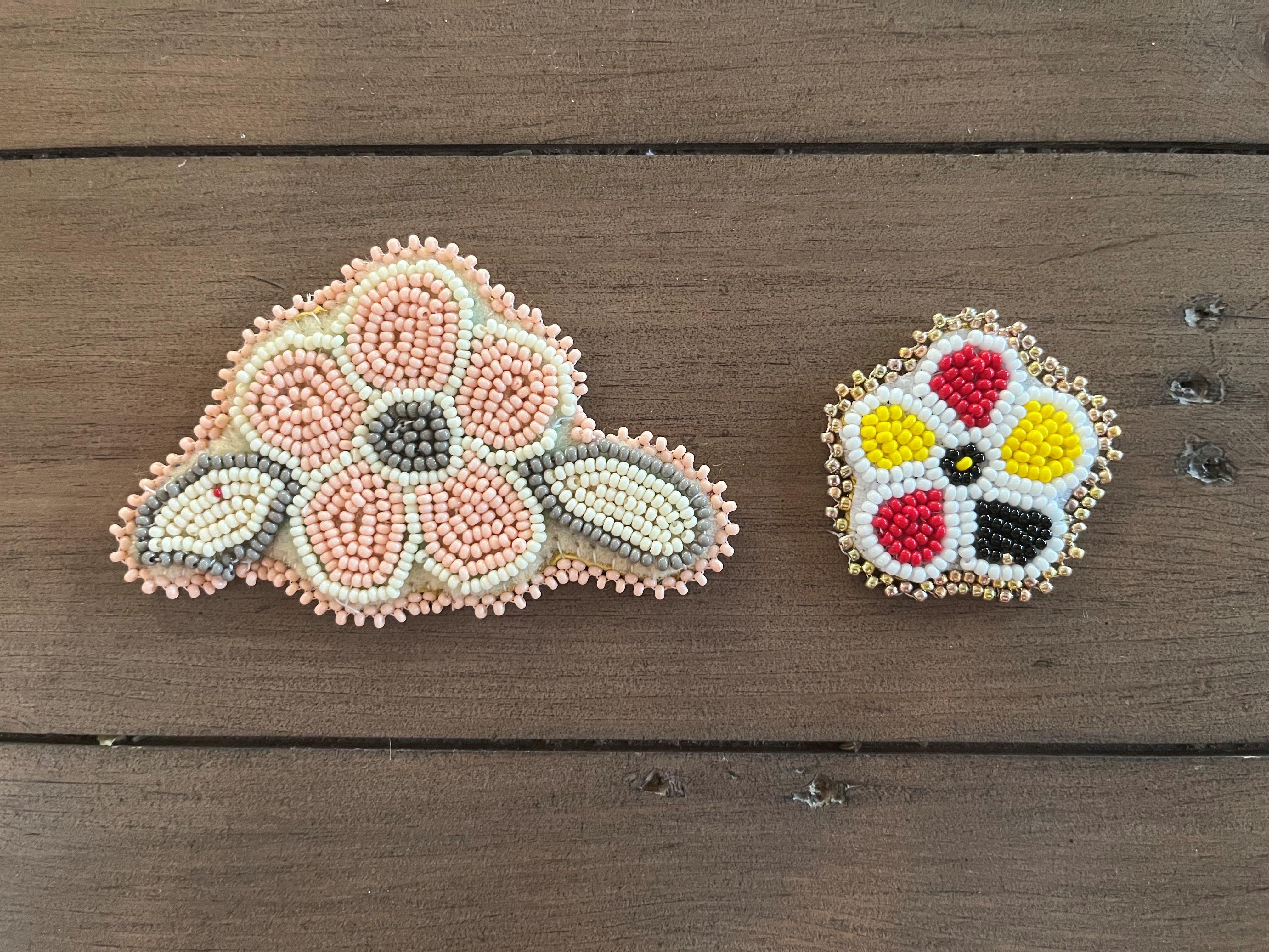 A close up of some beaded accessories in the shape of flowers 