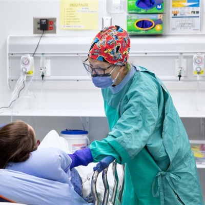 Nurse helping patient during surgery.