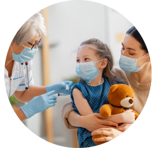 A nurse gives a child a vaccine who is sitting on her mother's lap.