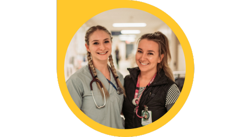 two girls in medical staff clothes smiling