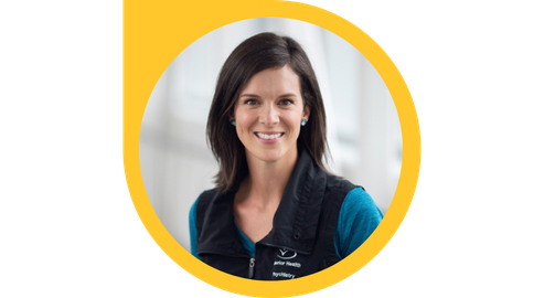 Headshot of a smiling person with long dark hair wearing an Interior Health vest in a circular yellow frame that forms into a triangle at the top left.