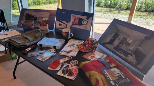 A table with project drawings and Indigenous gifts.