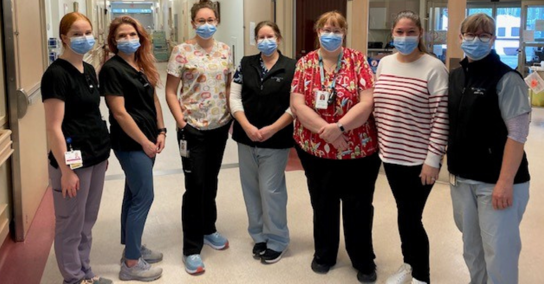 A group of health-care professionals wearing masks.