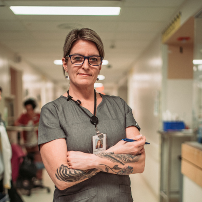 Smiling nurse in hospital setting.