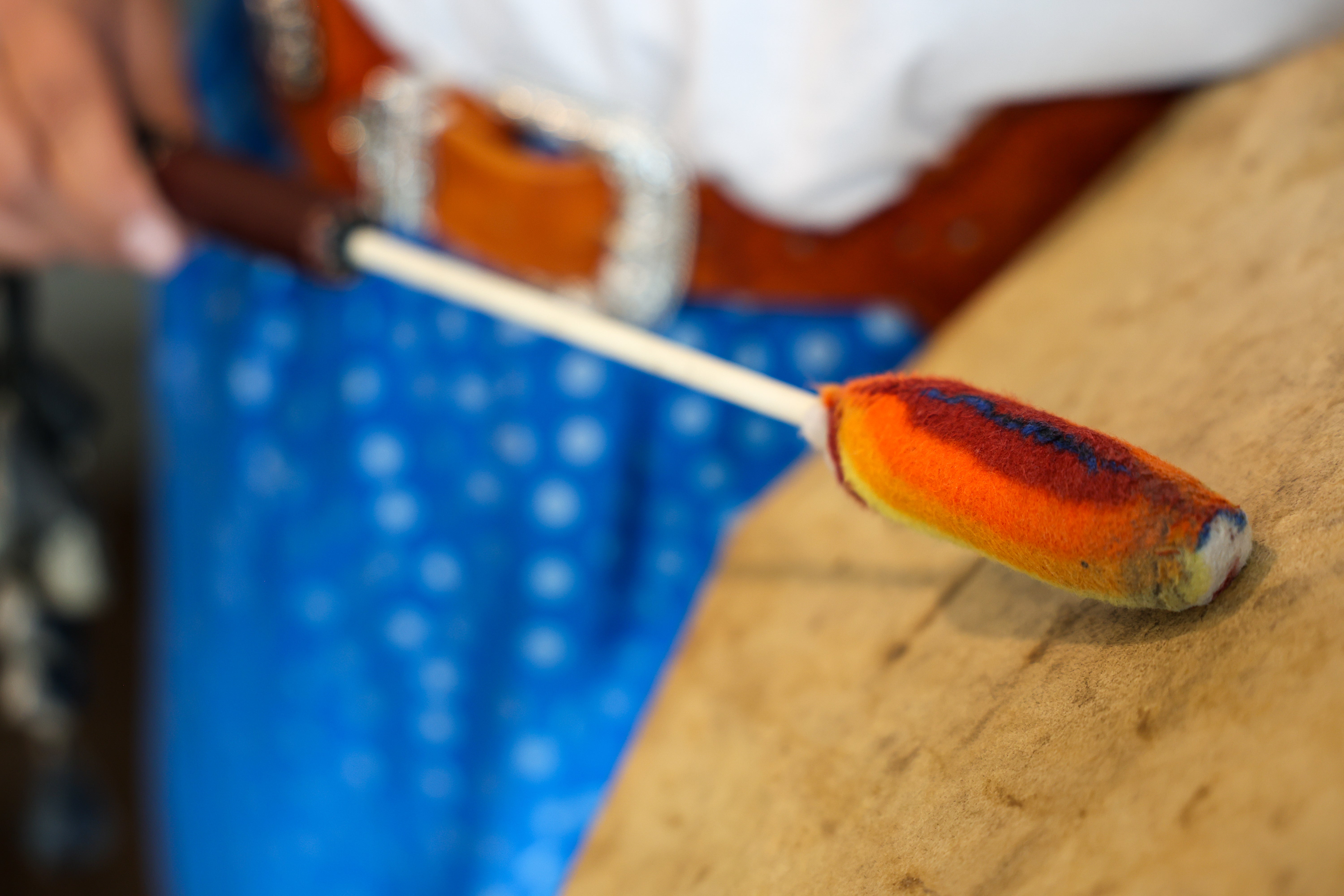 Close-up photo of a colourful Indigenous hand drum stick.