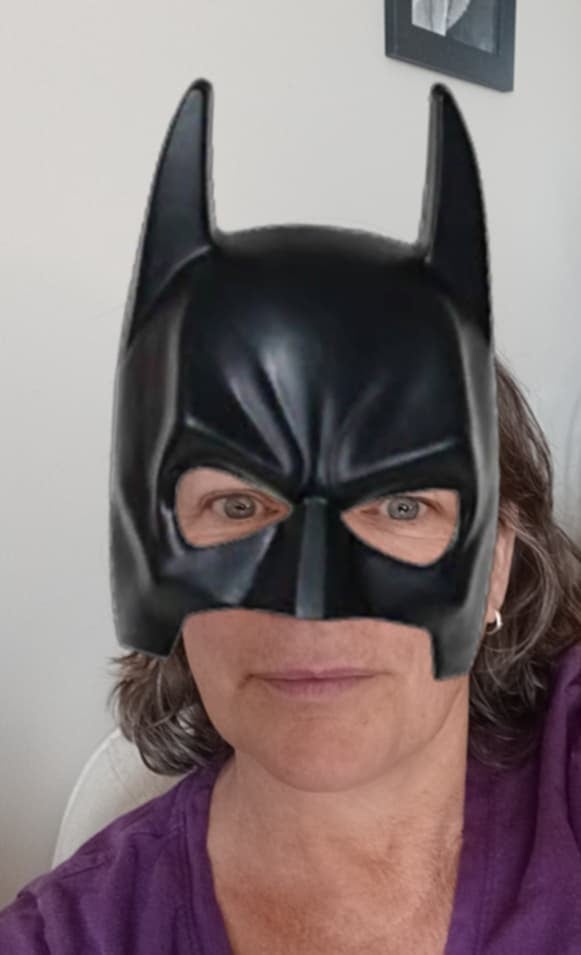 A person in a pretend black batwoman mask.