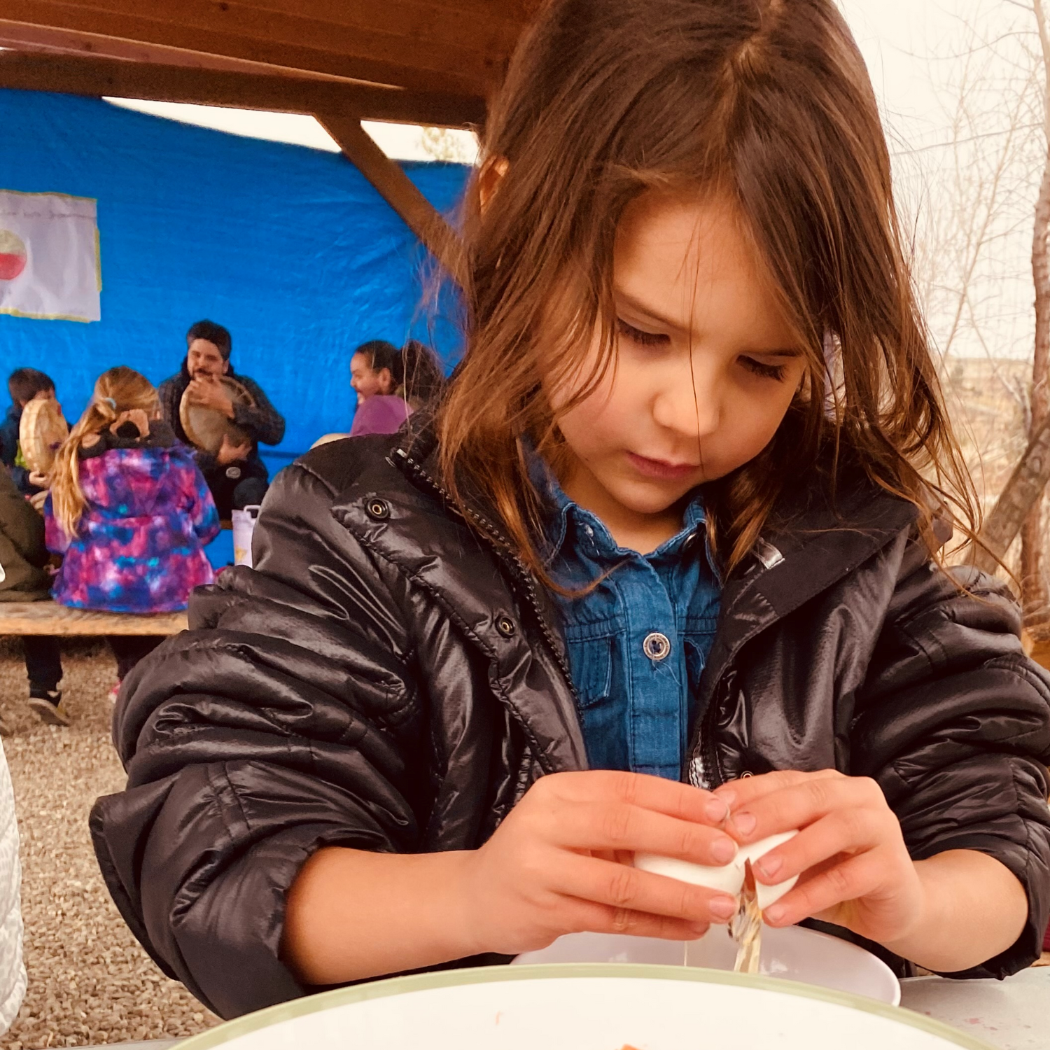 a young person cracks an egg