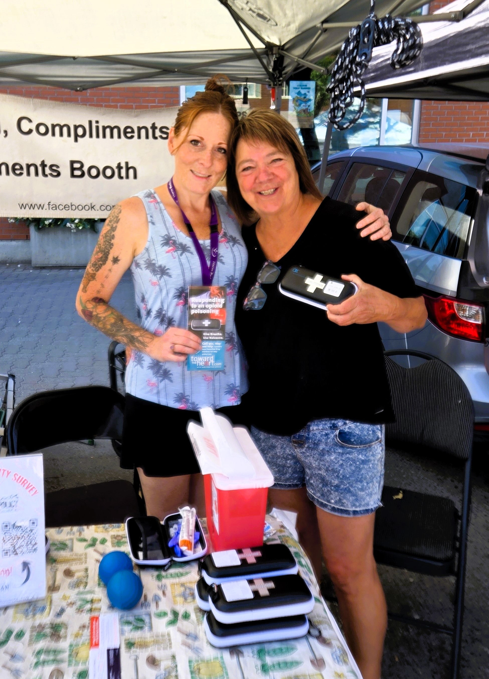 Jessica (left) and Gaudenza Ramunno (overdose prevention nurse with MHSU) at a booth at the Kamloops Farmers' Market to hand out naloxone and provide naloxone training.