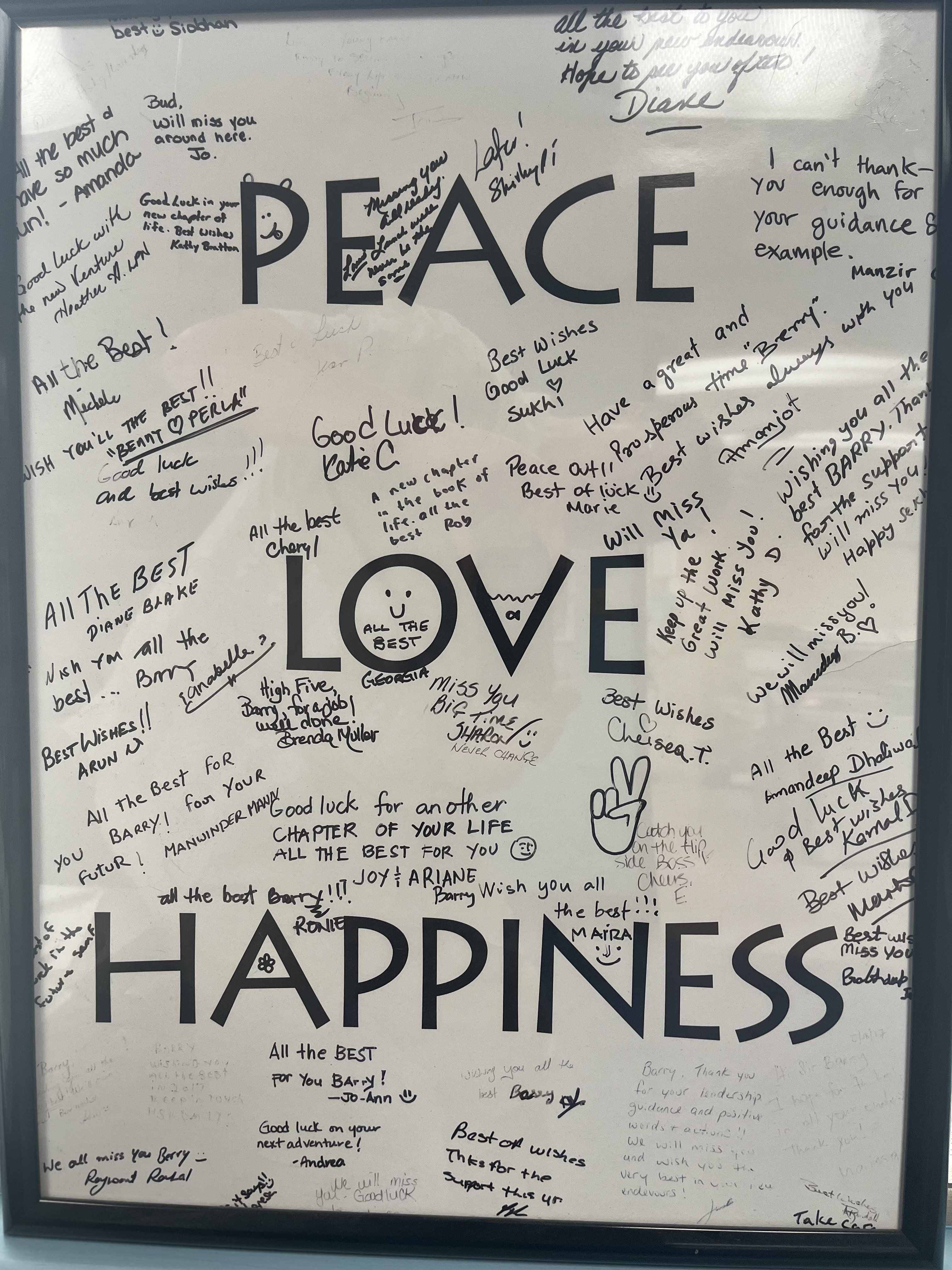 A whiteboard of messages around the words peace love happiness