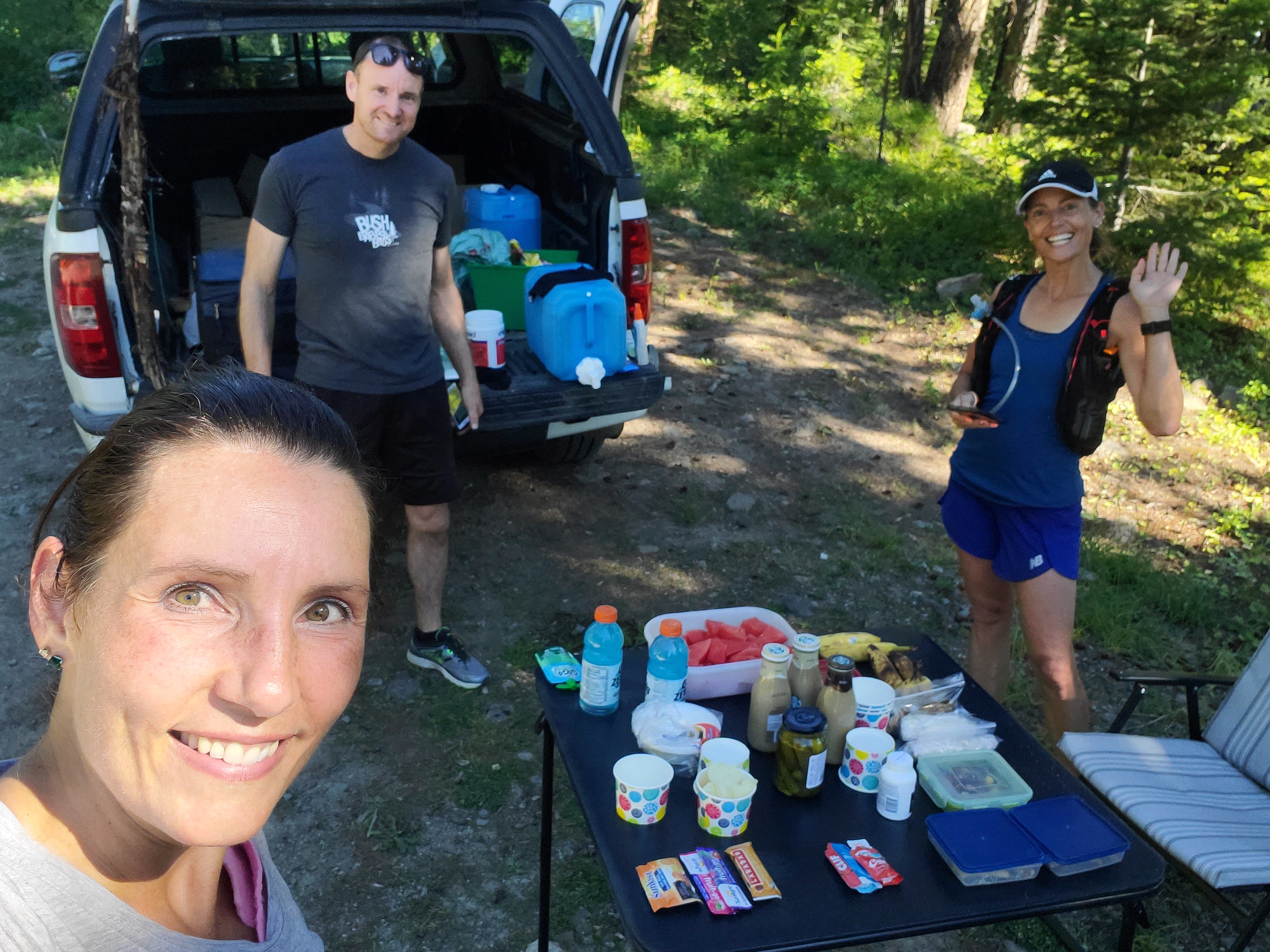 Two women wearing running gear in forest.