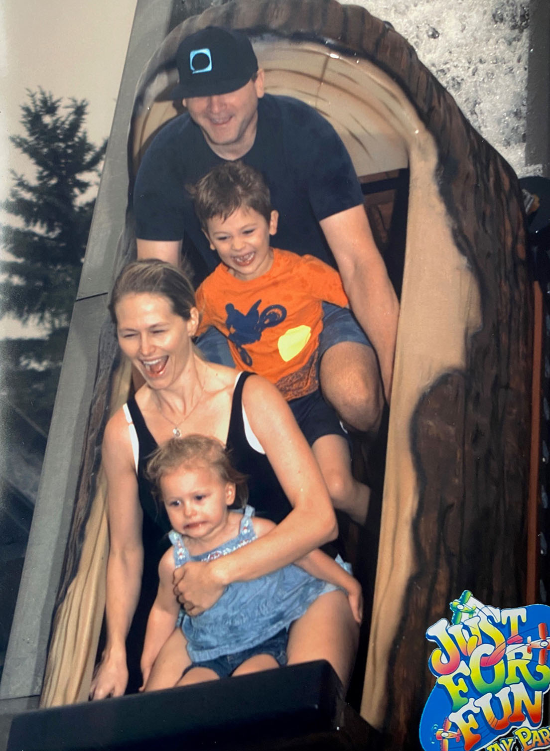 Chandra with her family riding the log flume at an amusement park