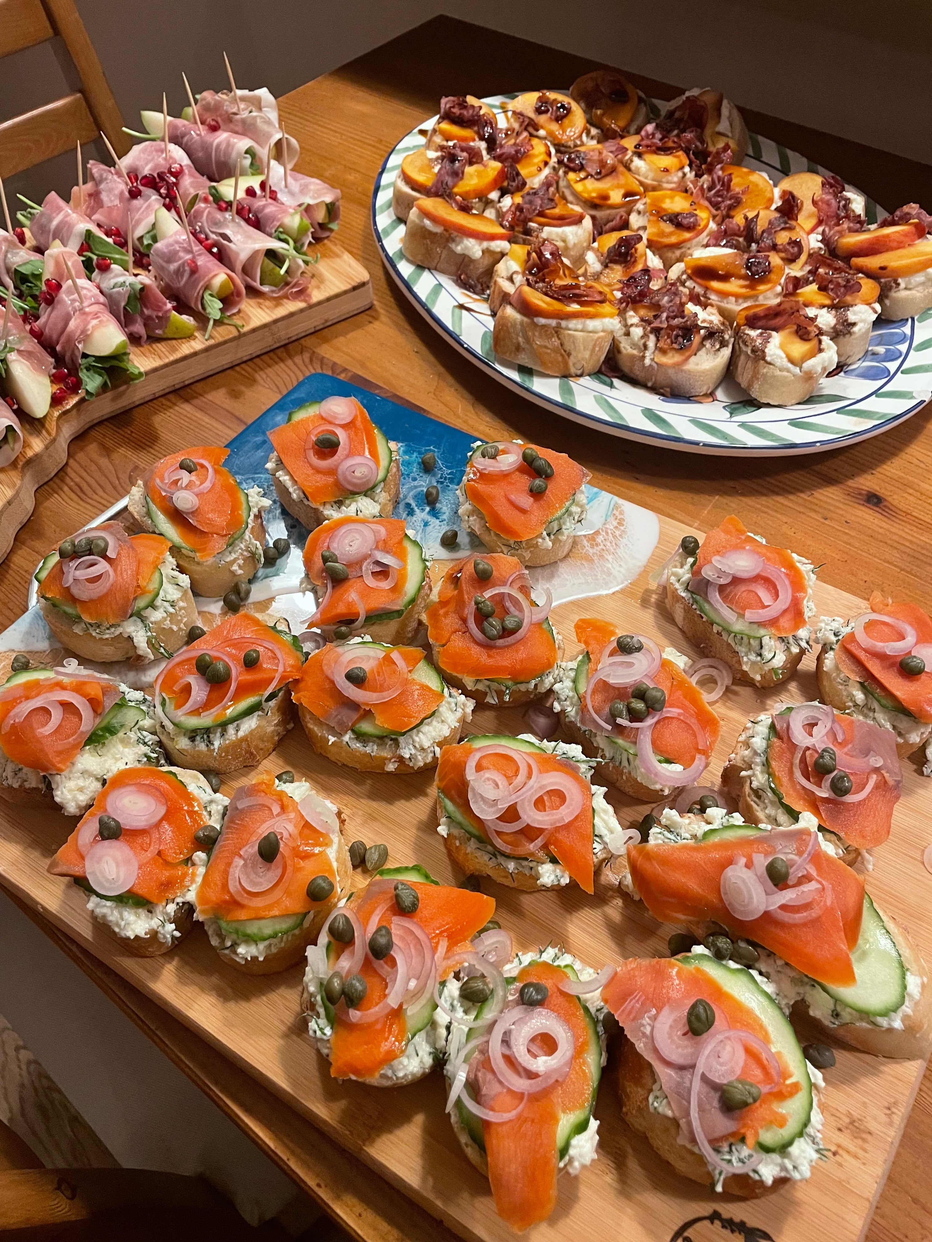 An assortment of appetizers displayed on cutting boards and a plate.