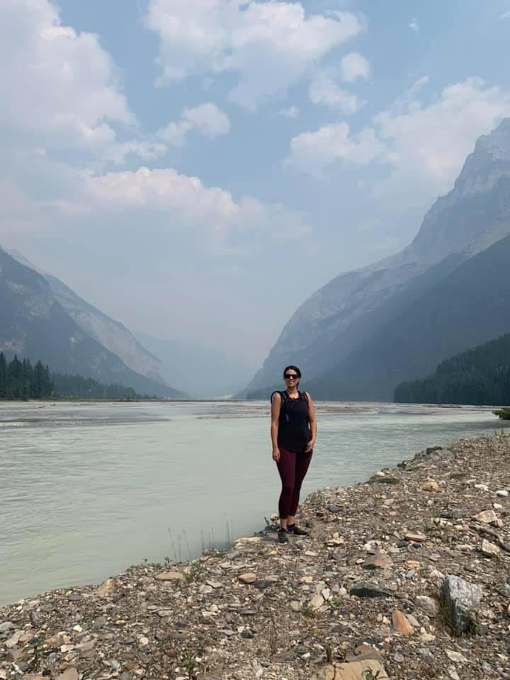 Woman standing at the water’s edge.