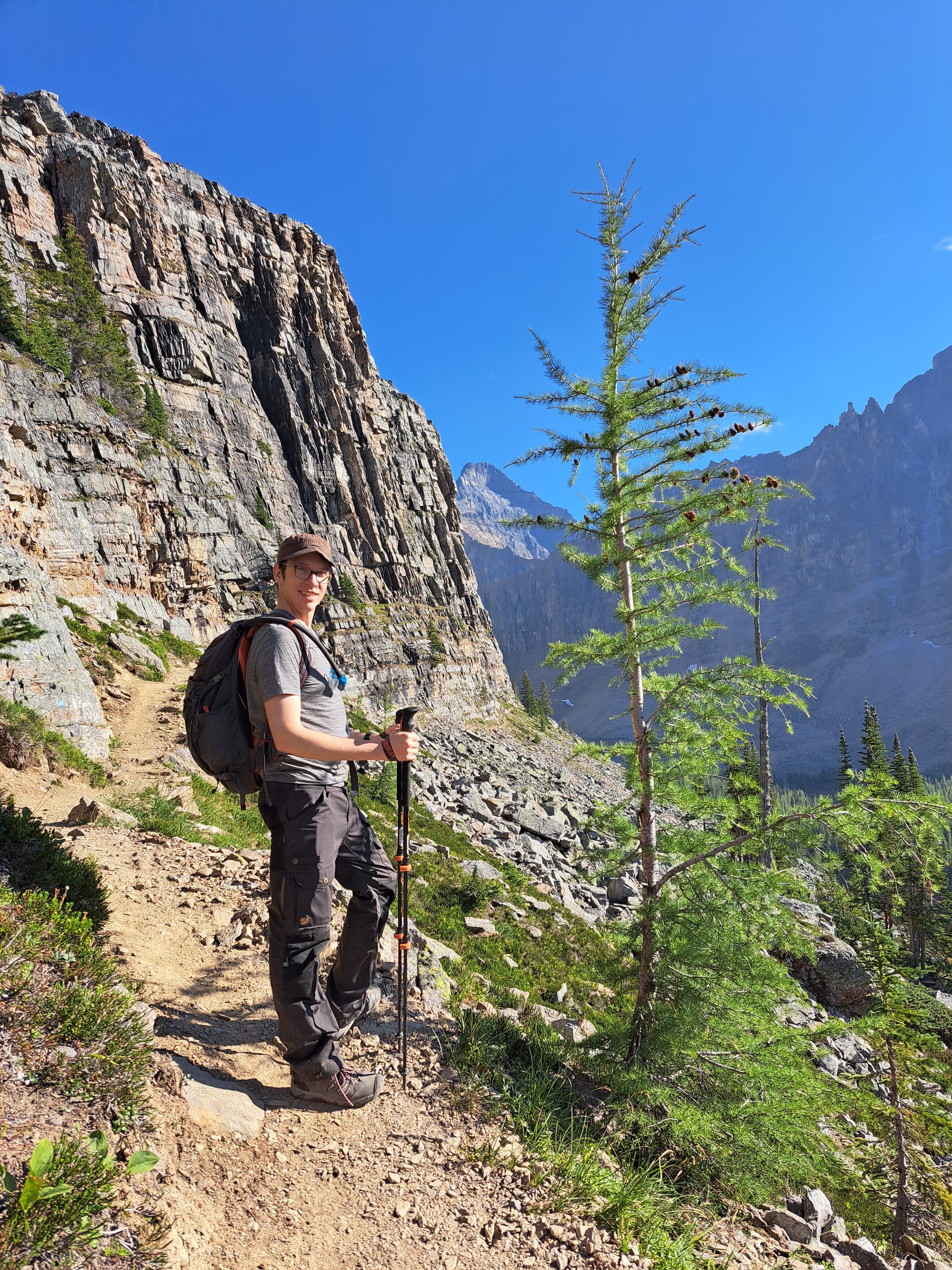 Man hiking on rocky path with mountain in background