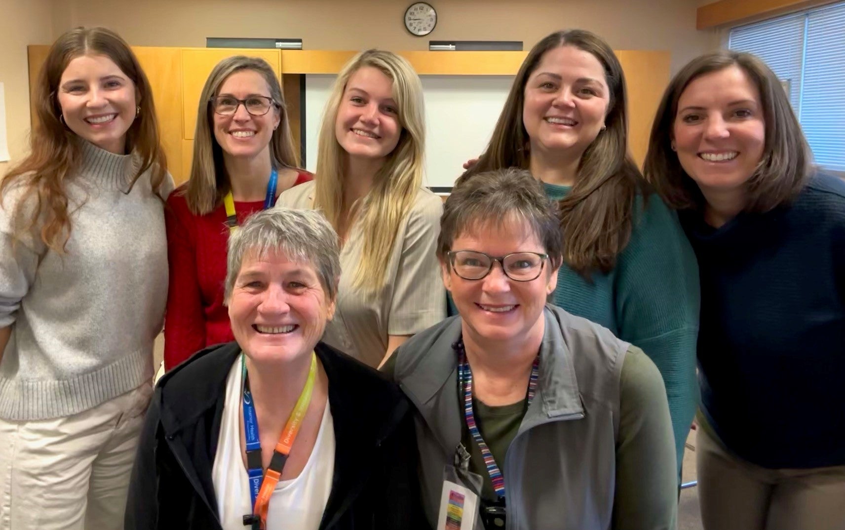 Seven people posing for a photo