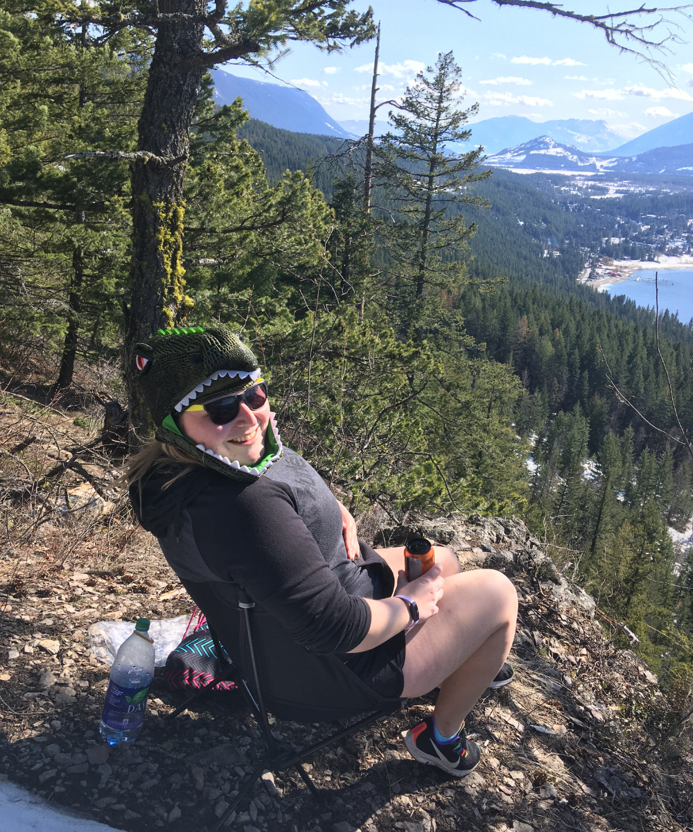 Woman sitting overlooking lake.