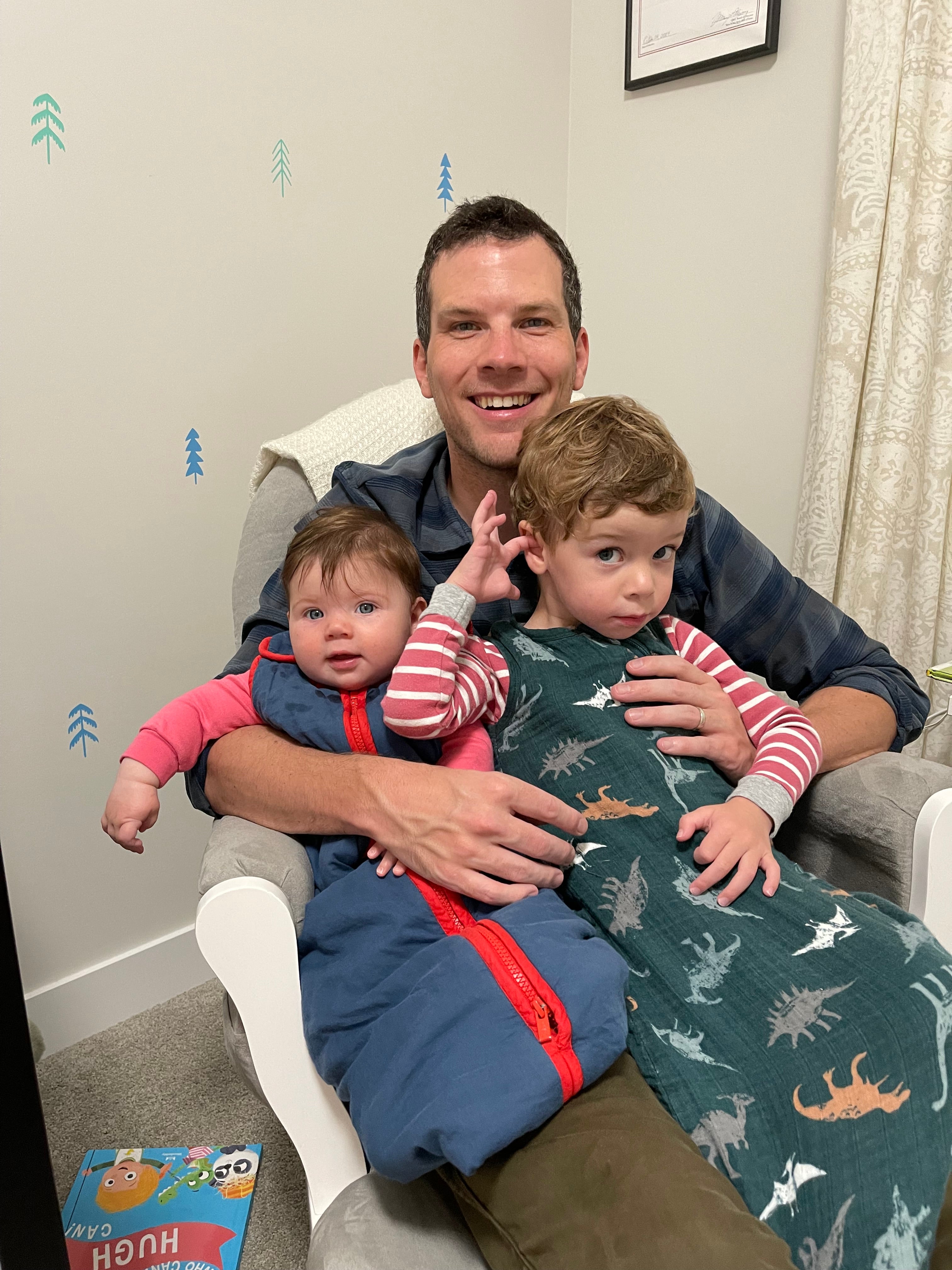 A man and two children on a chair.