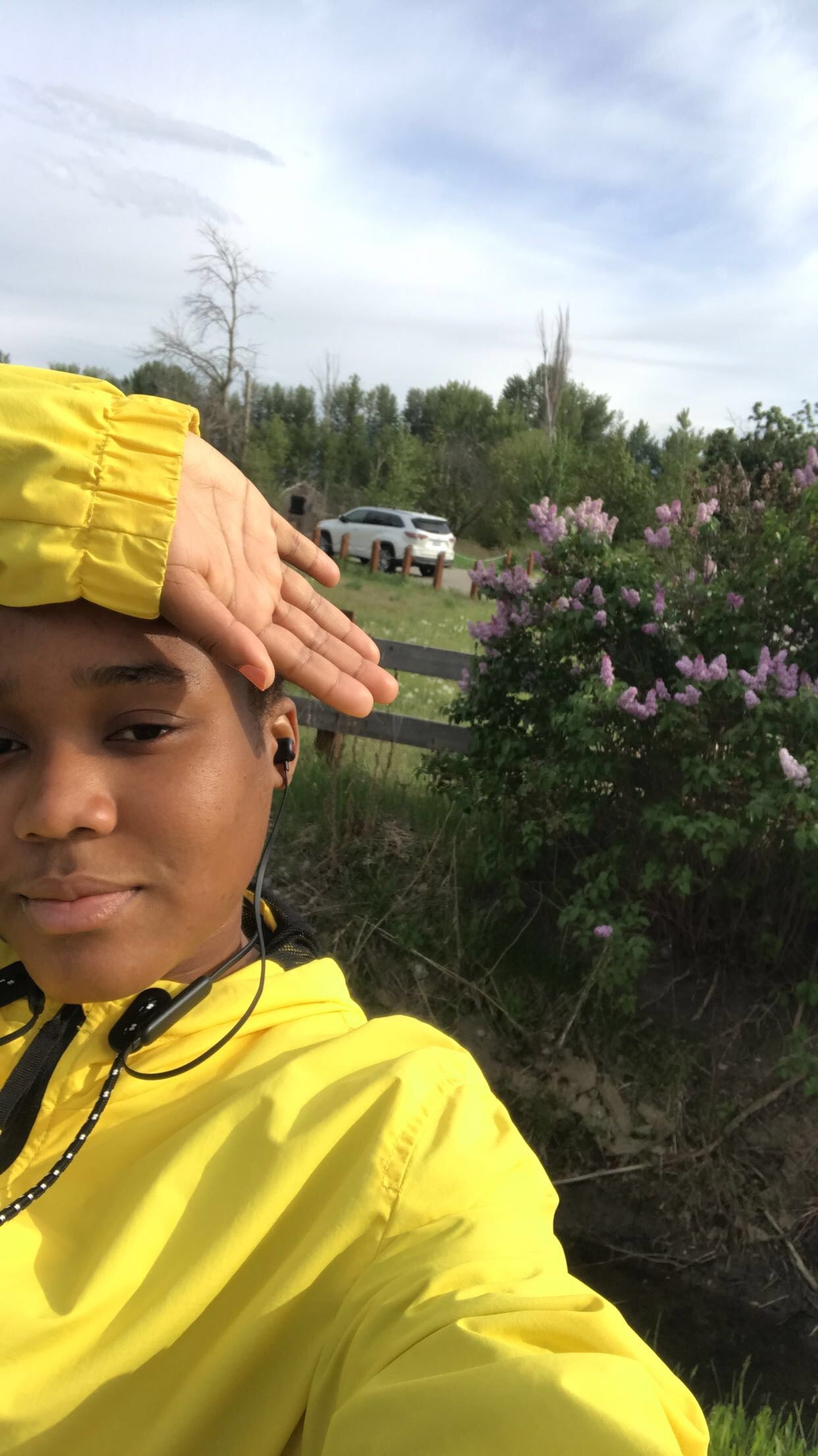 Woman outside in yellow jacket.