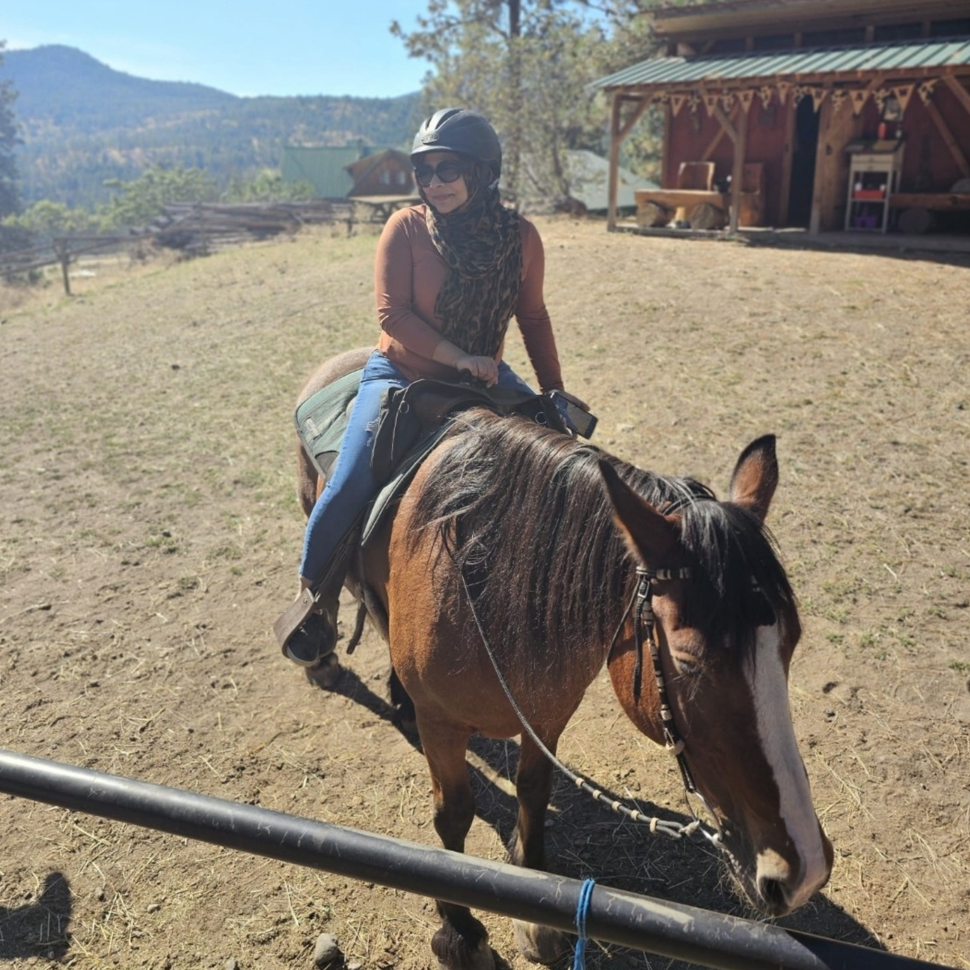 a women on horseback smiling for the camera