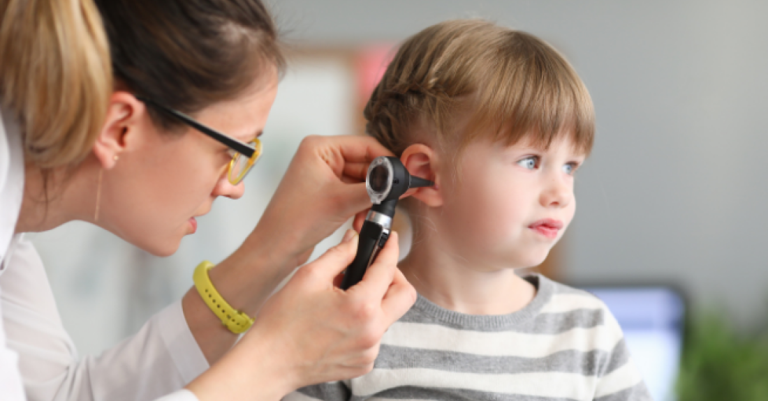 Girl gets her ear checked.