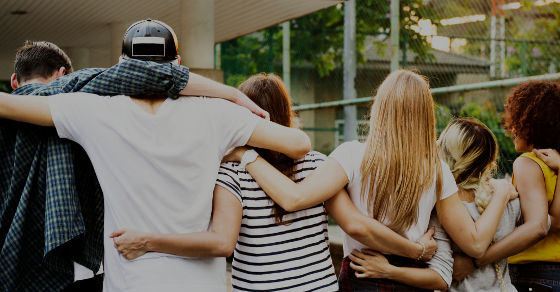 A group of teenagers linked together.