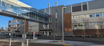 A large building with an indoor walkway extending out of it.