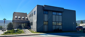A large building with a ramp leading up to the front doors.