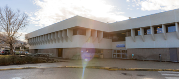 An exterior shot of a wide, modern-looking building.