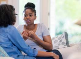 Two women have a conversation.