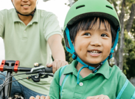 An adult and child riding bikes.