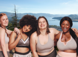 a group of women stand for a photo in workout clothes on a hike in BC