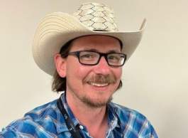 Man in checked shirt with cowboy hat