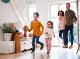 a family of 4 with a son and daughter enter their home