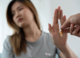 a woman puts her hand up when offered a cigarette 