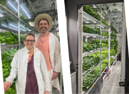 two people standing in front of plans in a green house with food plants