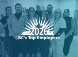 A blue-toned photo of a group of people with the words 2026 BC's Top Employer in front of a sun and mountains in white.