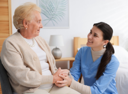 A senior smiling with a nurse.
