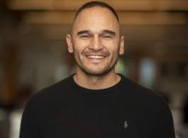 A smiling person wearing a black shirt.